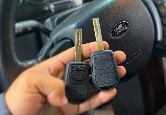 Image of keys of Land Rover over steering wheel.